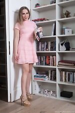 Margaret strips naked by her bookshelf today